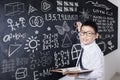 Student holds book and write formula Royalty Free Stock Photo