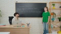 Student and Instructor Discuss Python Code in Modern Classroom