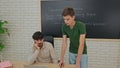 Student and Instructor Discuss Python Code in Modern Classroom