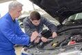 student with instructor repairing car during apprenticeship Royalty Free Stock Photo