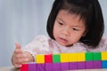 Student kid playing wooden blocks building tower and sort and stack toys. Royalty Free Stock Photo