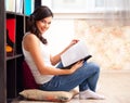 Student with a lbook in a library Royalty Free Stock Photo