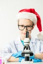 Student learning chemistry. Positive joyful smart boy testing and using a microscope in science class