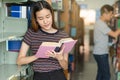 Student learning in library. Young read book in library for doing research assignment Royalty Free Stock Photo