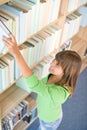 Student in library - happy woman choose book