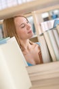 Student in library - happy woman study from book