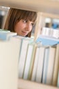 Student in library - happy woman study from book