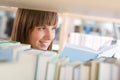 Student in library - happy woman study from book