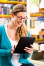 Student in library learning with tablet computer Royalty Free Stock Photo