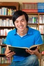 Student in library reading book Royalty Free Stock Photo