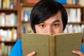 Student in library reading book Royalty Free Stock Photo