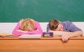 Student life issues. Guy and girl tired or lazy student lean on desk in classroom. Feeling bored. Studying in college or Royalty Free Stock Photo