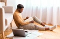 African Guy Preparing For Exam Sitting On Floor At Home Royalty Free Stock Photo