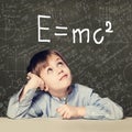 Student little boy and science background. Kid with science formulas Royalty Free Stock Photo