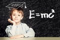 Student little boy and science background. Kid is thinking about science formula Royalty Free Stock Photo