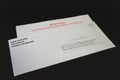 Student Loan Payments Resuming Notice in Envelope on Black Desk, left angled. Royalty Free Stock Photo