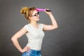 Woman holding big oversized pencil thinking about something Royalty Free Stock Photo