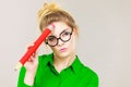 Woman holding big oversized pencil thinking about something Royalty Free Stock Photo