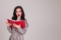 Girl student looks into book and shows unhappy face