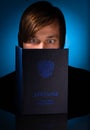 Student looks at his diploma with a surprised look. blue color. Written by - Supplement about higher education Royalty Free Stock Photo