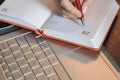 Student making notes on the table with a laptop Royalty Free Stock Photo