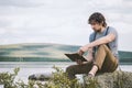 Student man reading book outdoor self education