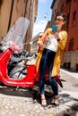 Student near red scooter in the city Royalty Free Stock Photo