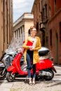 Student near red scooter in the city Royalty Free Stock Photo