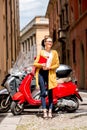 Student near red scooter in the city Royalty Free Stock Photo