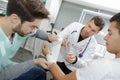 Student nurse bandaging patient`s wrist under supervision Royalty Free Stock Photo