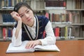 Student with open textbook deep in thought