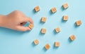 Student organizing wooden cubes with education icons. Education concept Royalty Free Stock Photo
