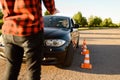 Student passes between cones, driving school