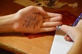 Cheat sheet on the hand. Formula written in the palm of a schoolboy. Hint in the palm of your hand Royalty Free Stock Photo