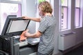 Student photocopying his book in the library