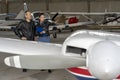 Student Pilot and Instructor Check an Aircraft for Safety in a Hangar