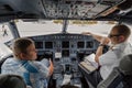 Student and pilot talking in the plane cockpit