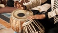 A Student playing with Indian traditional musical instrument `Tabla`.