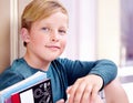 Student, portrait and boy with book in hallway with education, study and textbook for back to school. Youth, young kid Royalty Free Stock Photo