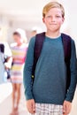 Student, portrait and boy with kids in hallway with education, study and backpack for back to school. Youth, young kid Royalty Free Stock Photo