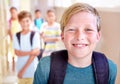 Student, portrait and child with smile in hallway with education, study and backpack for back to school. Youth, young Royalty Free Stock Photo