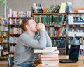 Student prays before examination in a library