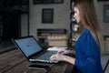 Student preparing for classes surfing the internet on her laptop sitting at table in trendy cafe