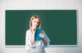 Student preparing exam and learning lessons in school classroom. Female student taking notes from a book in college. Royalty Free Stock Photo