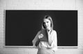 Student preparing exam and learning lessons in school classroom. Female student taking notes from a book in college. Royalty Free Stock Photo