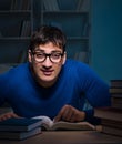 Student preparing for exams late at night in library Royalty Free Stock Photo