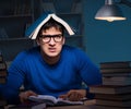 Student preparing for exams late at night in library Royalty Free Stock Photo