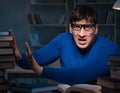 Student preparing for exams late at night in library Royalty Free Stock Photo