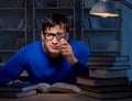 Student preparing for exams late at night in library Royalty Free Stock Photo