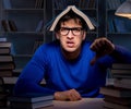 Student preparing for exams late at night in library Royalty Free Stock Photo